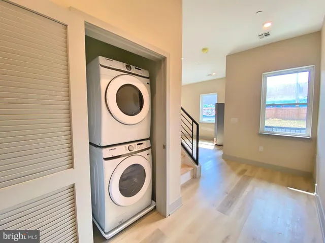 a view of a hallway with washer and dryer