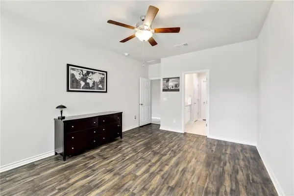 a workspace with wooden floor and windows