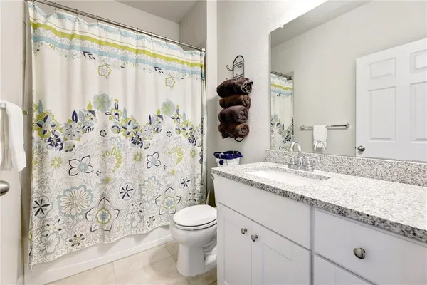 a bathroom with a shower and a sink