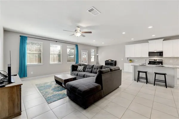 a bathroom with a granite countertop sink a toilet and a shower curtain
