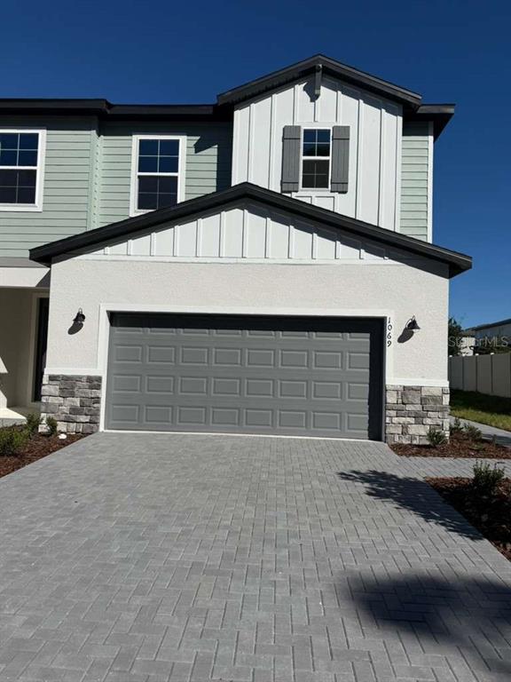a front view of a house with a yard and garage