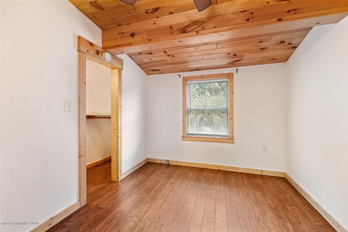 3600 Leghorn Road Grant Valkaria, FL 32950 - Photo 25 of 33 an empty room with wooden floor and windows
