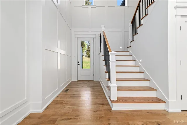 a view of entryway and hall with wooden floor