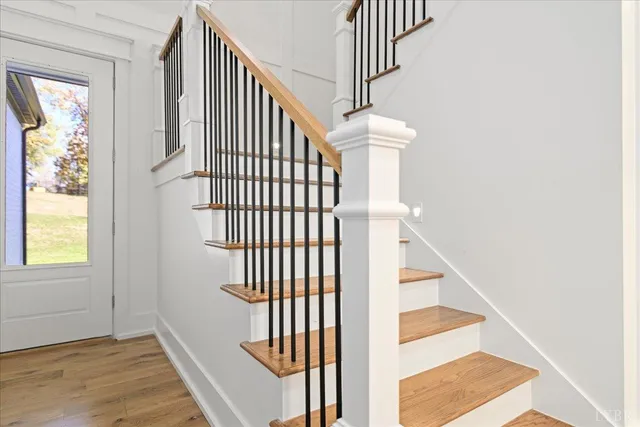 a view of entryway and hall with wooden floor