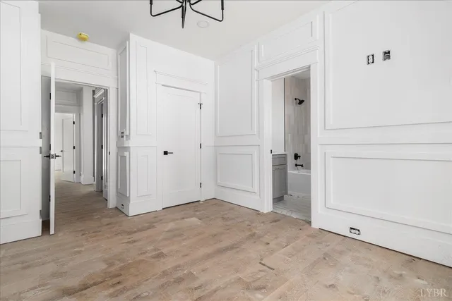 an empty room with windows and a ceiling fan