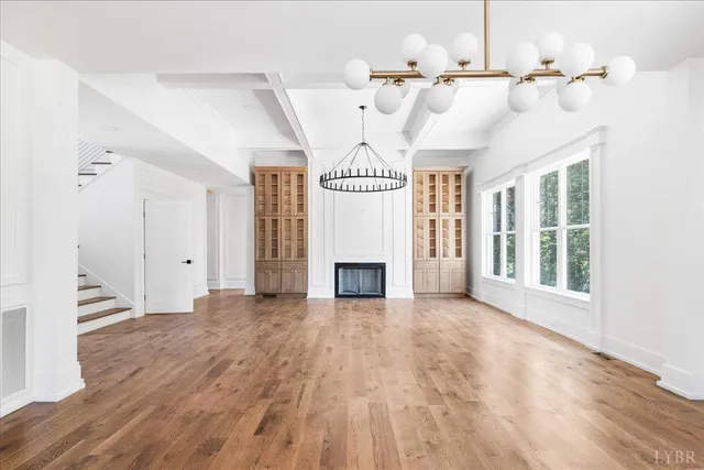 a view of an empty room with a fireplace and a window