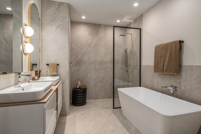 8000 O Connor Drive, Unit 104 River Grove, IL 60171 - Photo 11 of 20 a bathroom with a tub a sink and mirror