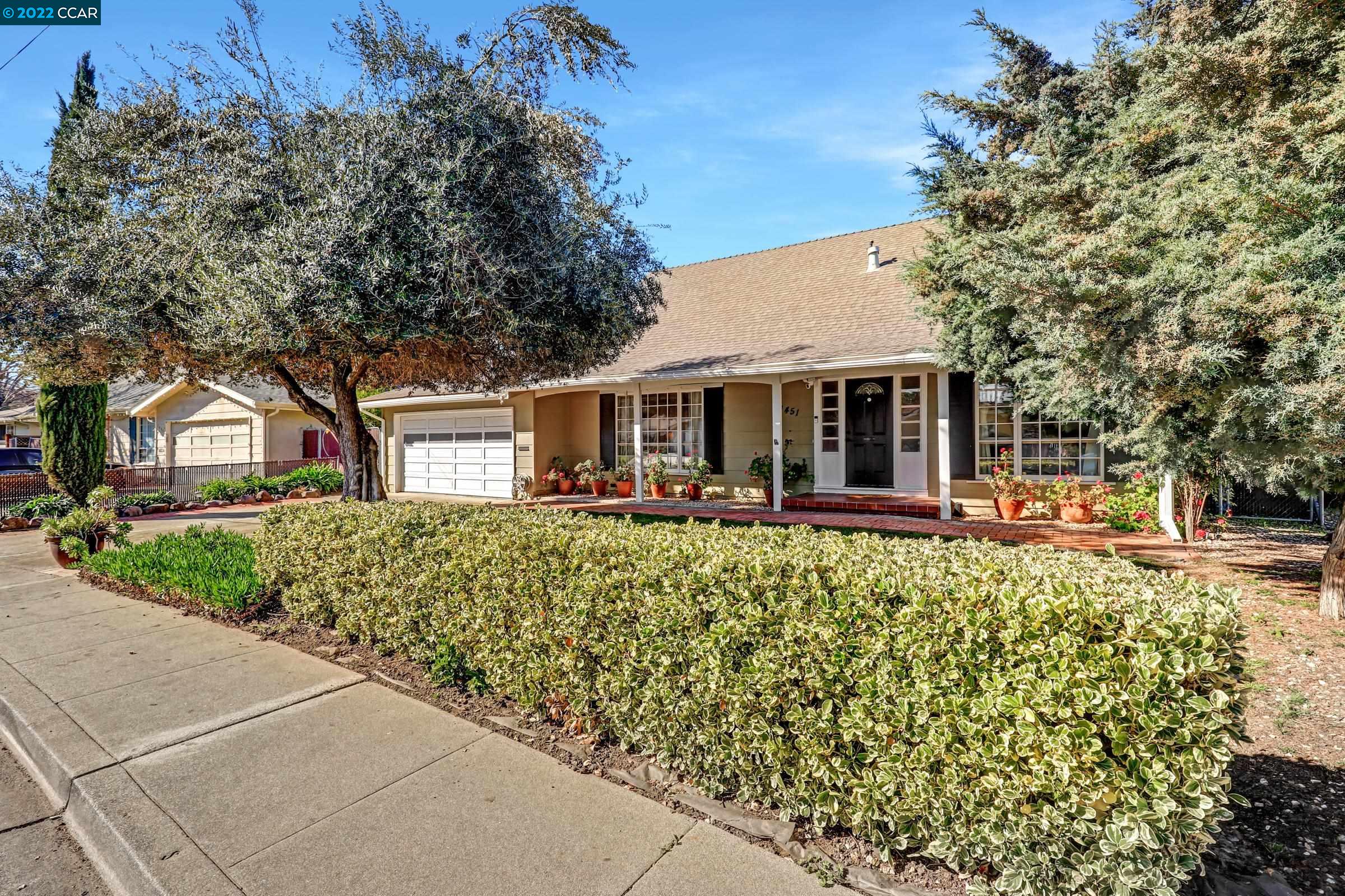 a front view of a house with a garden