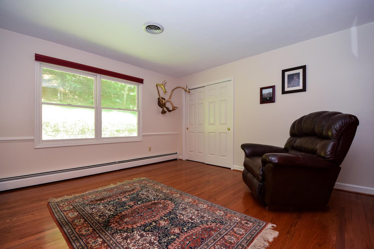 4848 Deerfield Road Southwest Roanoke, VA 24018 - Photo 25 of 59 a living room with furniture and a rug