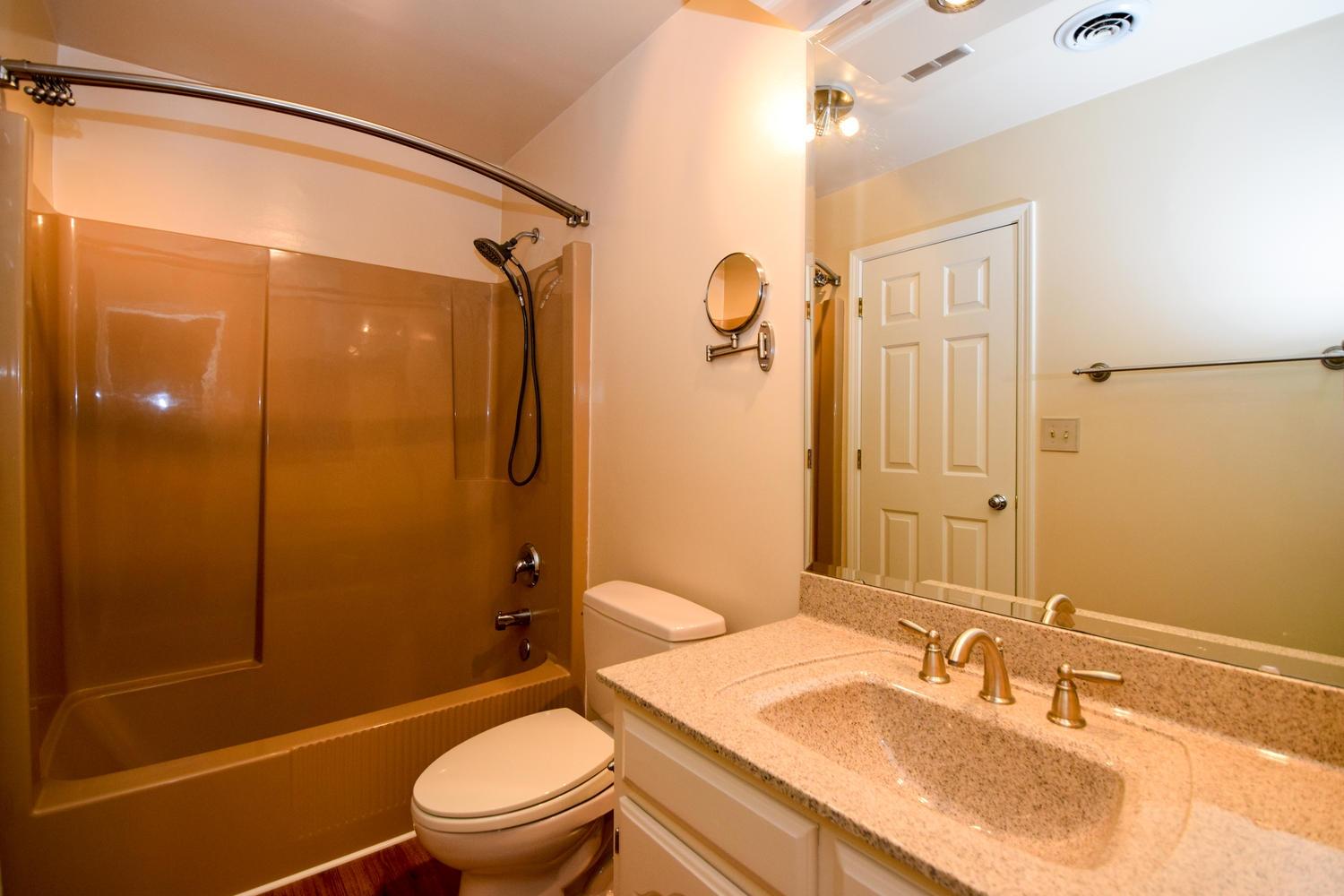 4848 Deerfield Road Southwest Roanoke, VA 24018 - Photo 26 of 59 a bathroom with a granite countertop sink toilet and shower