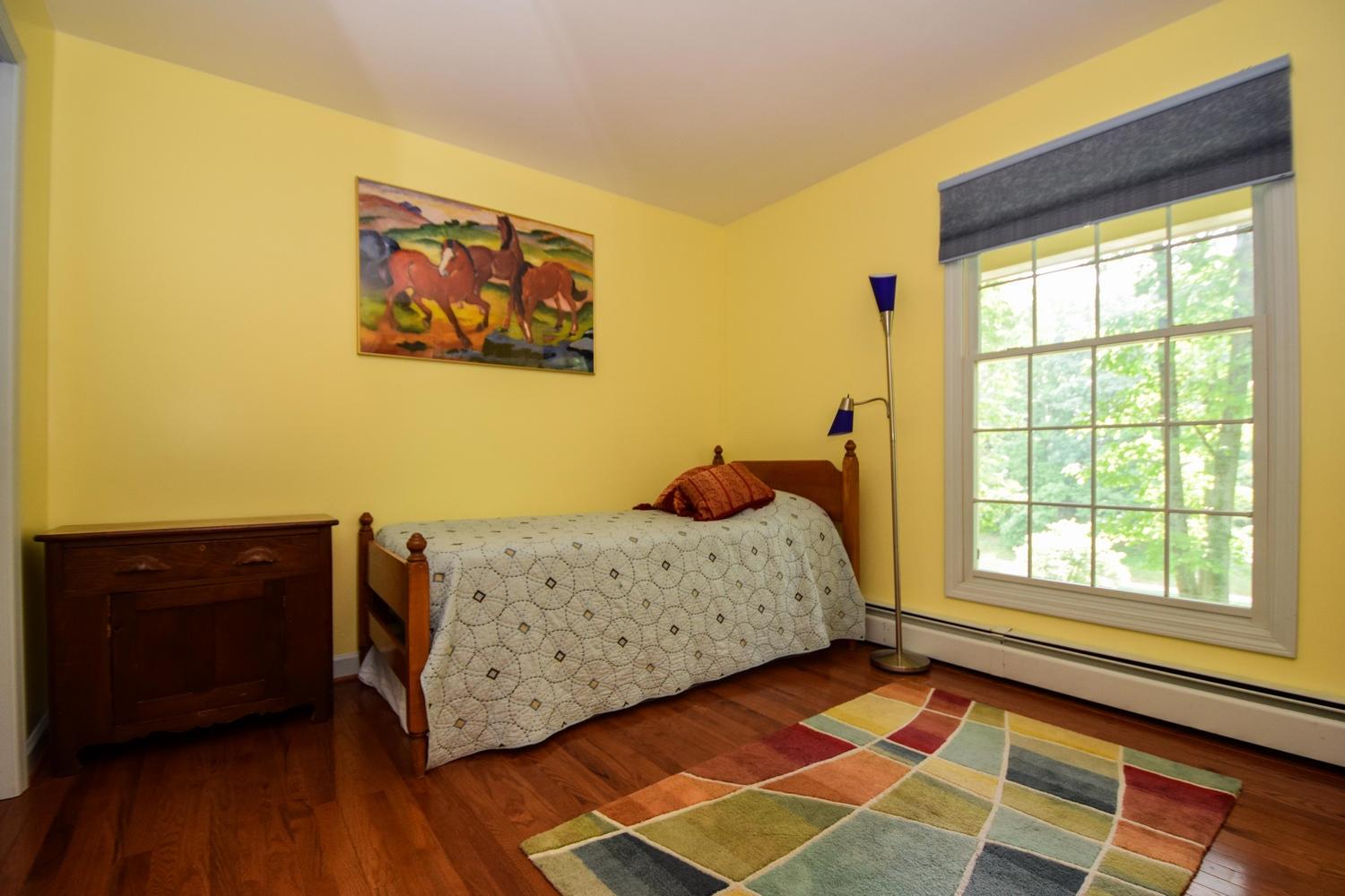 4848 Deerfield Road Southwest Roanoke, VA 24018 - Photo 27 of 59 a bedroom with a bed and wooden floor