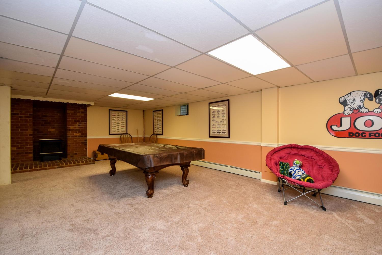 4848 Deerfield Road Southwest Roanoke, VA 24018 - Photo 39 of 59 a living room with furniture a flat screen tv and a table