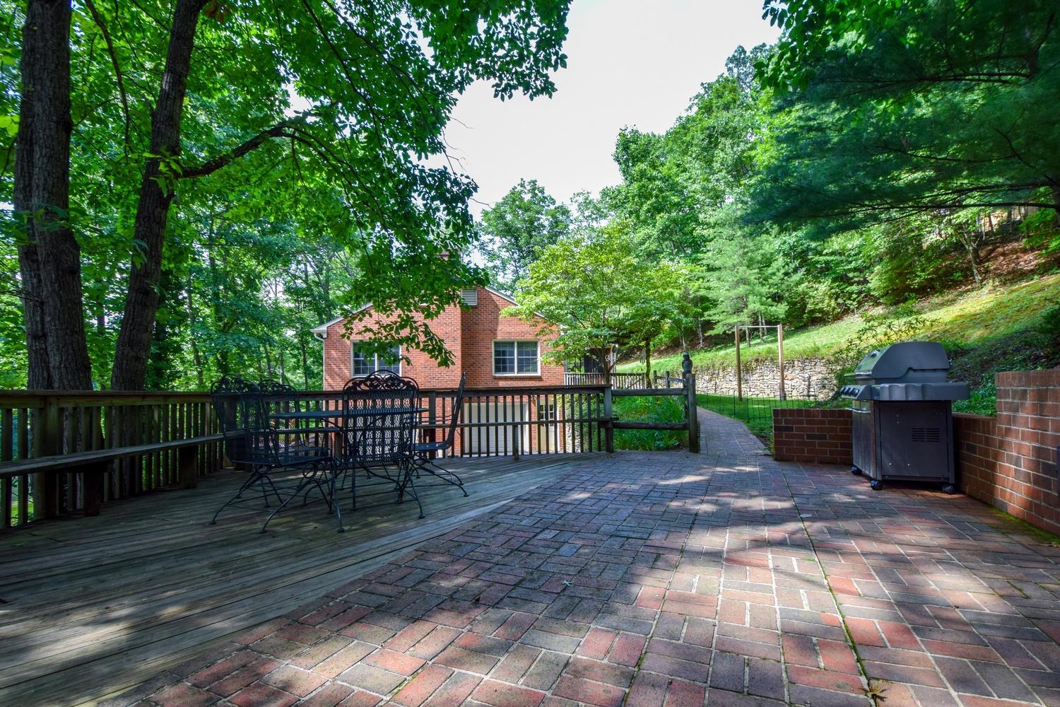 4848 Deerfield Road Southwest Roanoke, VA 24018 - Photo 51 of 59 a view of a backyard with wooden fence and a large tree
