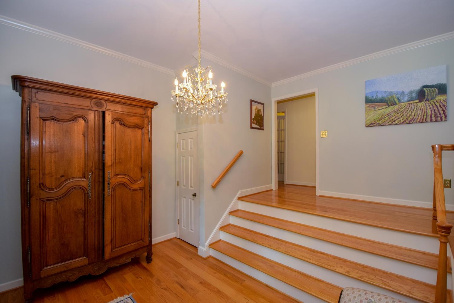 4848 Deerfield Road Southwest Roanoke, VA 24018 - Photo 8 of 59 a view of a hallway with wooden floor and staircase