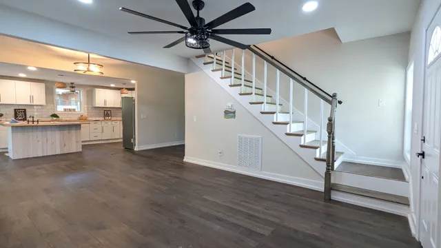 a view of entryway and hall with wooden floor