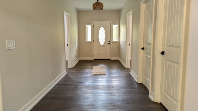 a view of a hallway with wooden floor