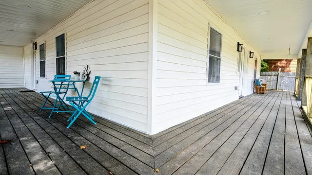 a view of a patio with table and chairs