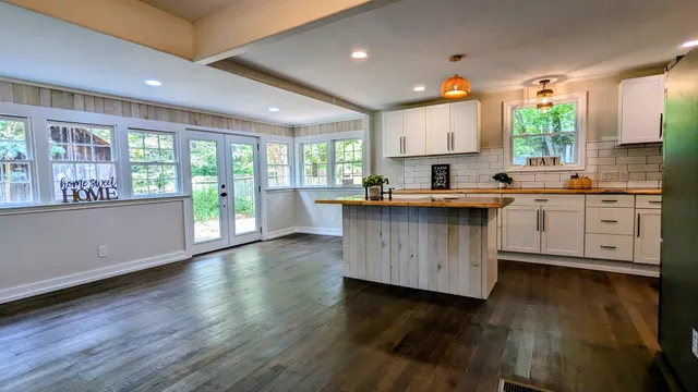 a kitchen with stainless steel appliances granite countertop wooden floors and sink