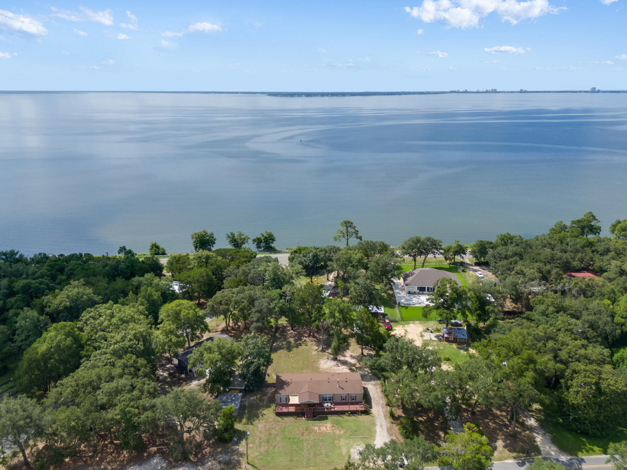 508 Live Oak Street Freeport, FL 32439 - Photo 14 of 47 an aerial view of a house with a yard and lake view