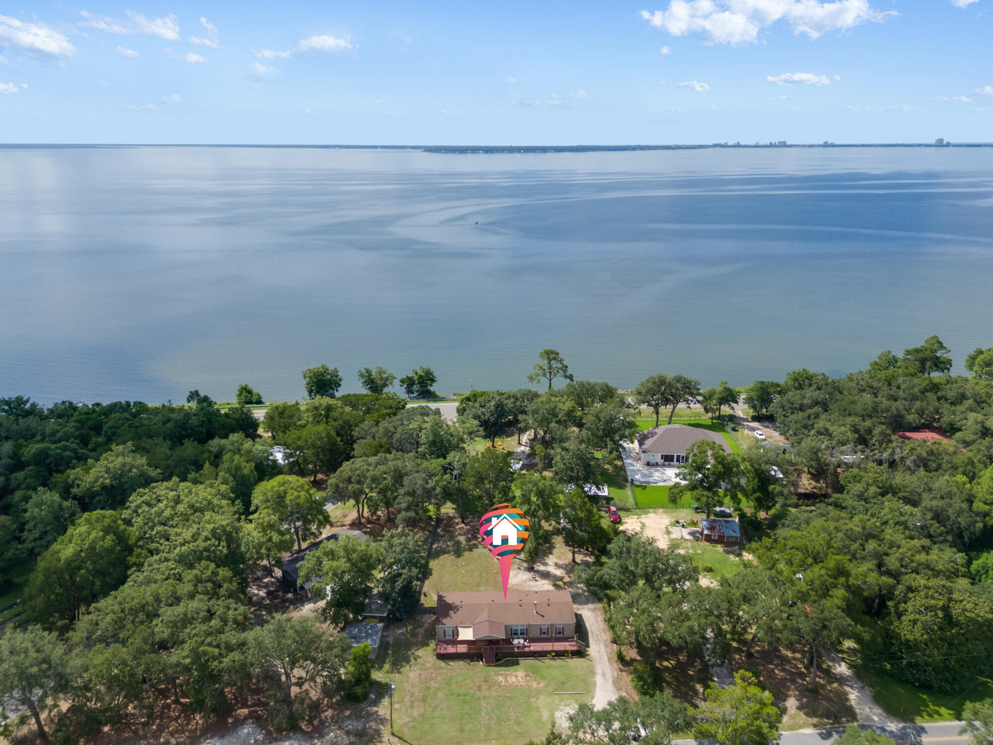 508 Live Oak Street Freeport, FL 32439 - Photo 2 of 47 an aerial view of a house with a yard and lake view