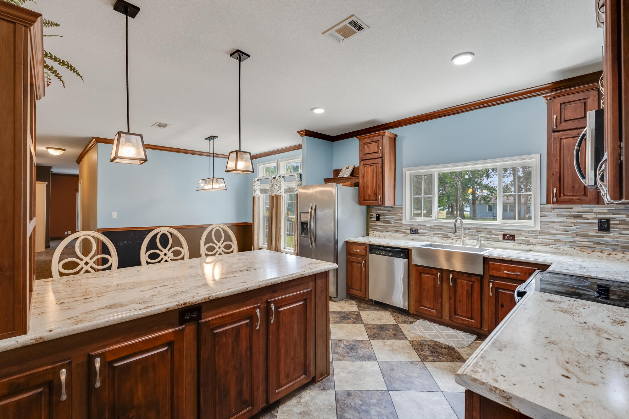 508 Live Oak Street Freeport, FL 32439 - Photo 23 of 47 a kitchen with stainless steel appliances granite countertop a sink a stove and a wooden floor