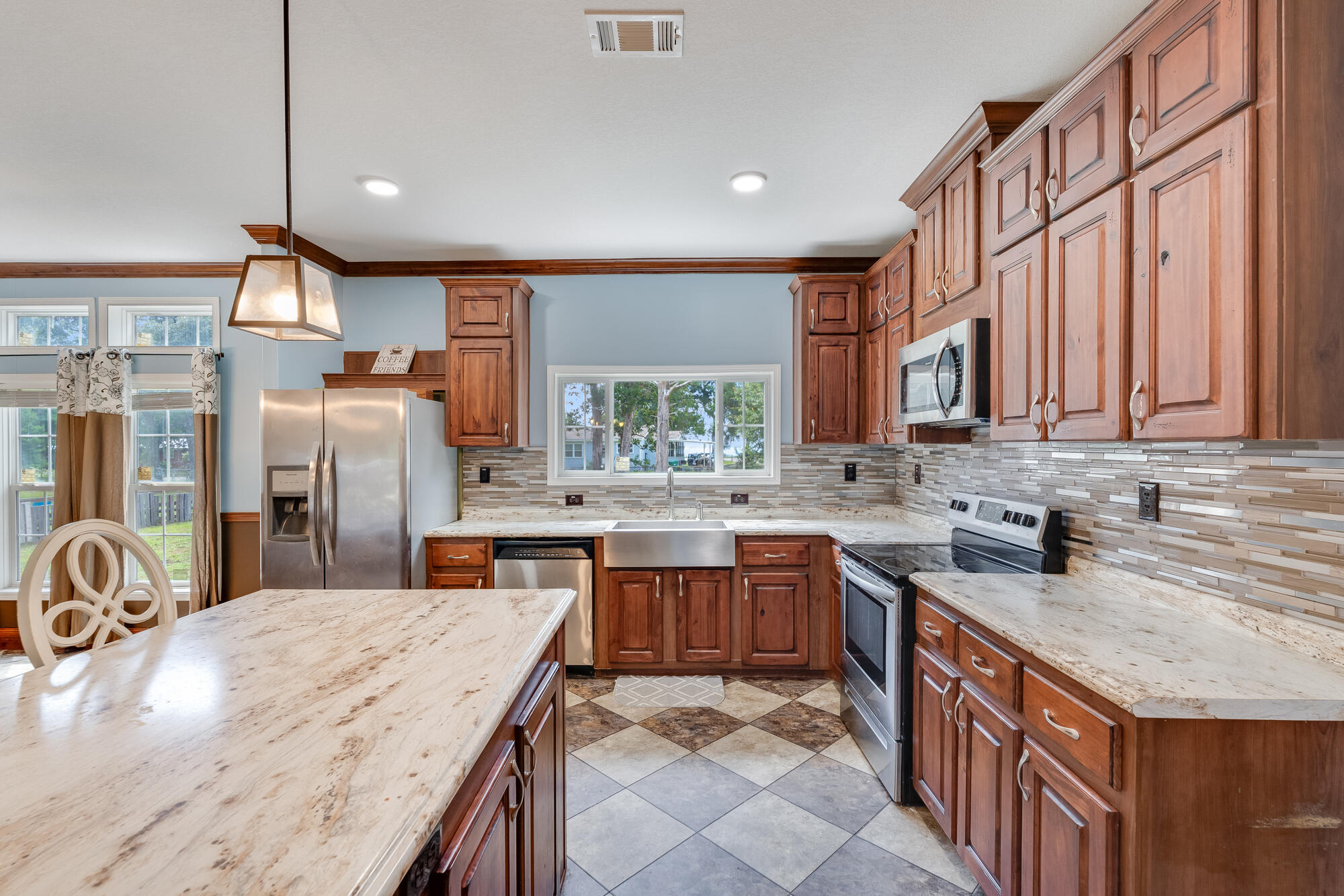 508 Live Oak Street Freeport, FL 32439 - Photo 24 of 47 a kitchen with stainless steel appliances granite countertop sink stove top oven and cabinets