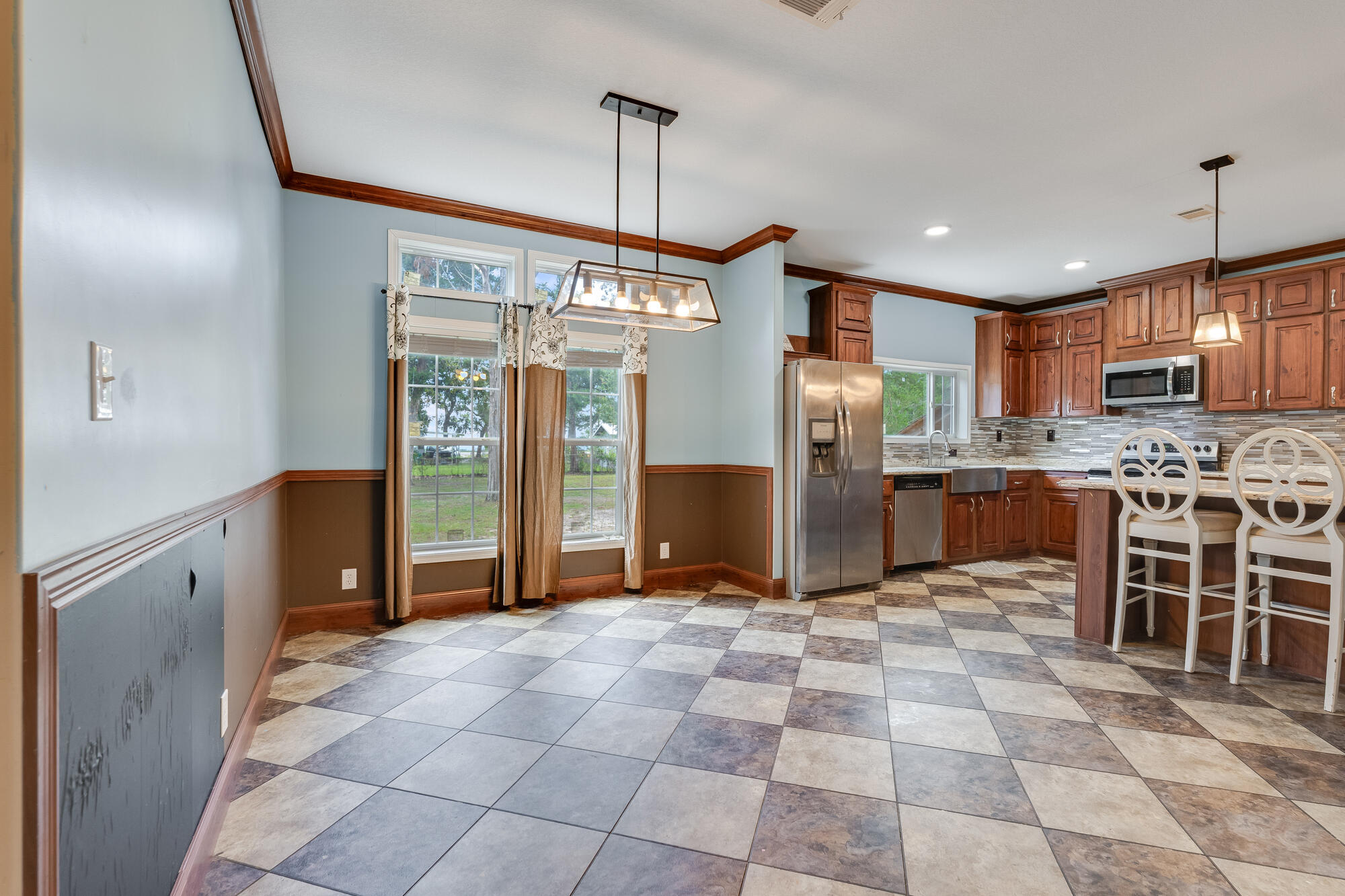508 Live Oak Street Freeport, FL 32439 - Photo 29 of 47 a kitchen with stainless steel appliances granite countertop a refrigerator and microwave