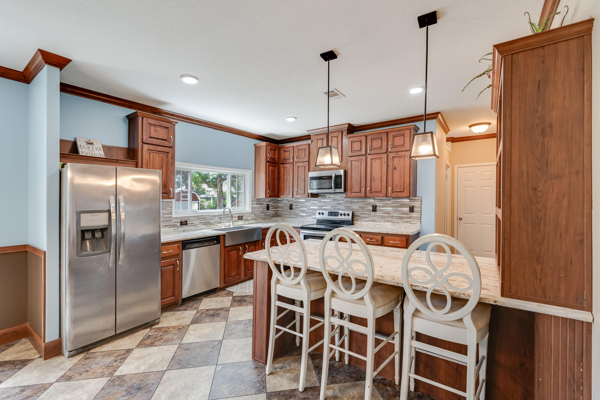 508 Live Oak Street Freeport, FL 32439 - Photo 3 of 47 a kitchen with stainless steel appliances granite countertop a refrigerator a stove and a sink