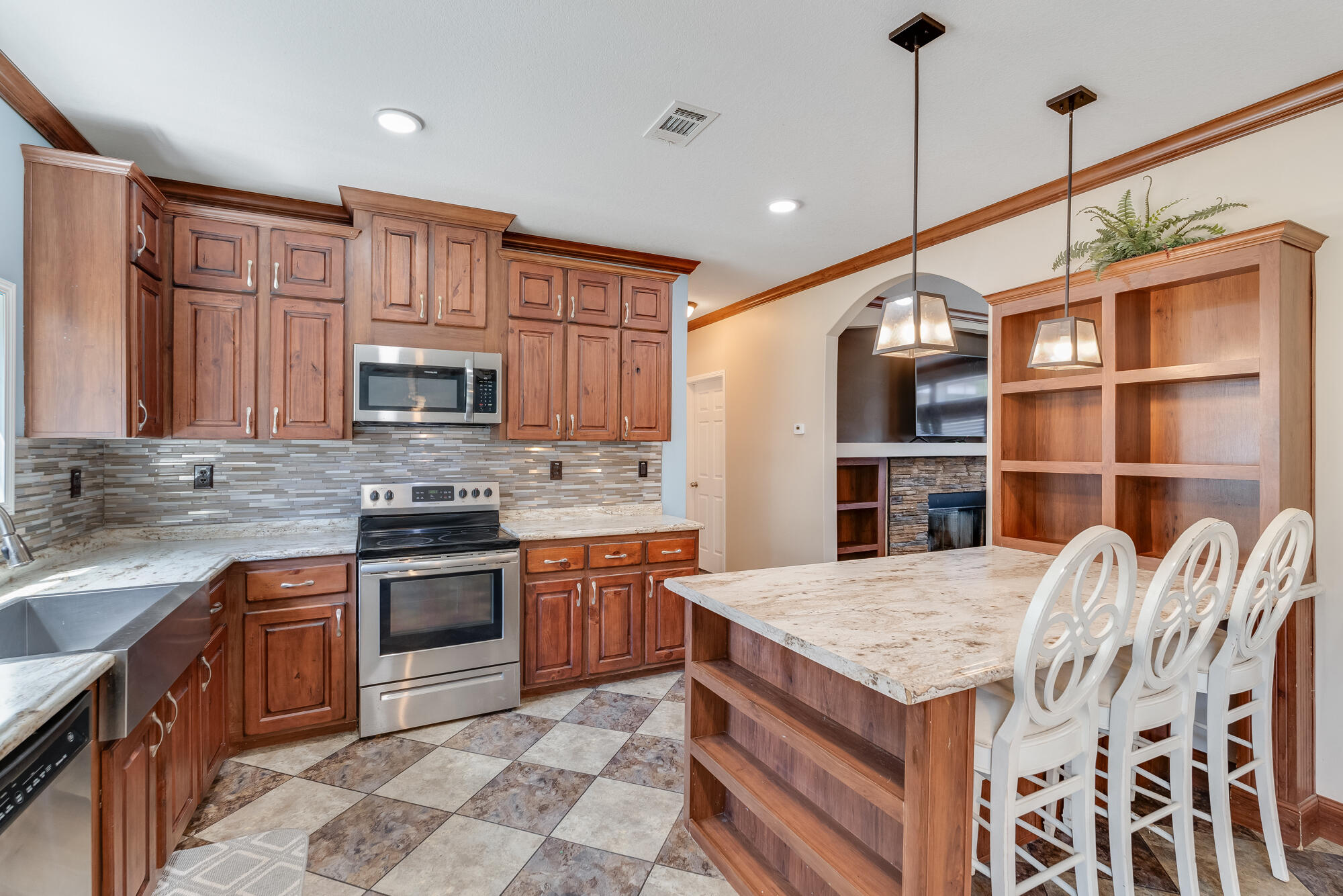 508 Live Oak Street Freeport, FL 32439 - Photo 4 of 47 a kitchen with stainless steel appliances granite countertop a stove a sink dishwasher a microwave oven with cabinets and wooden floor