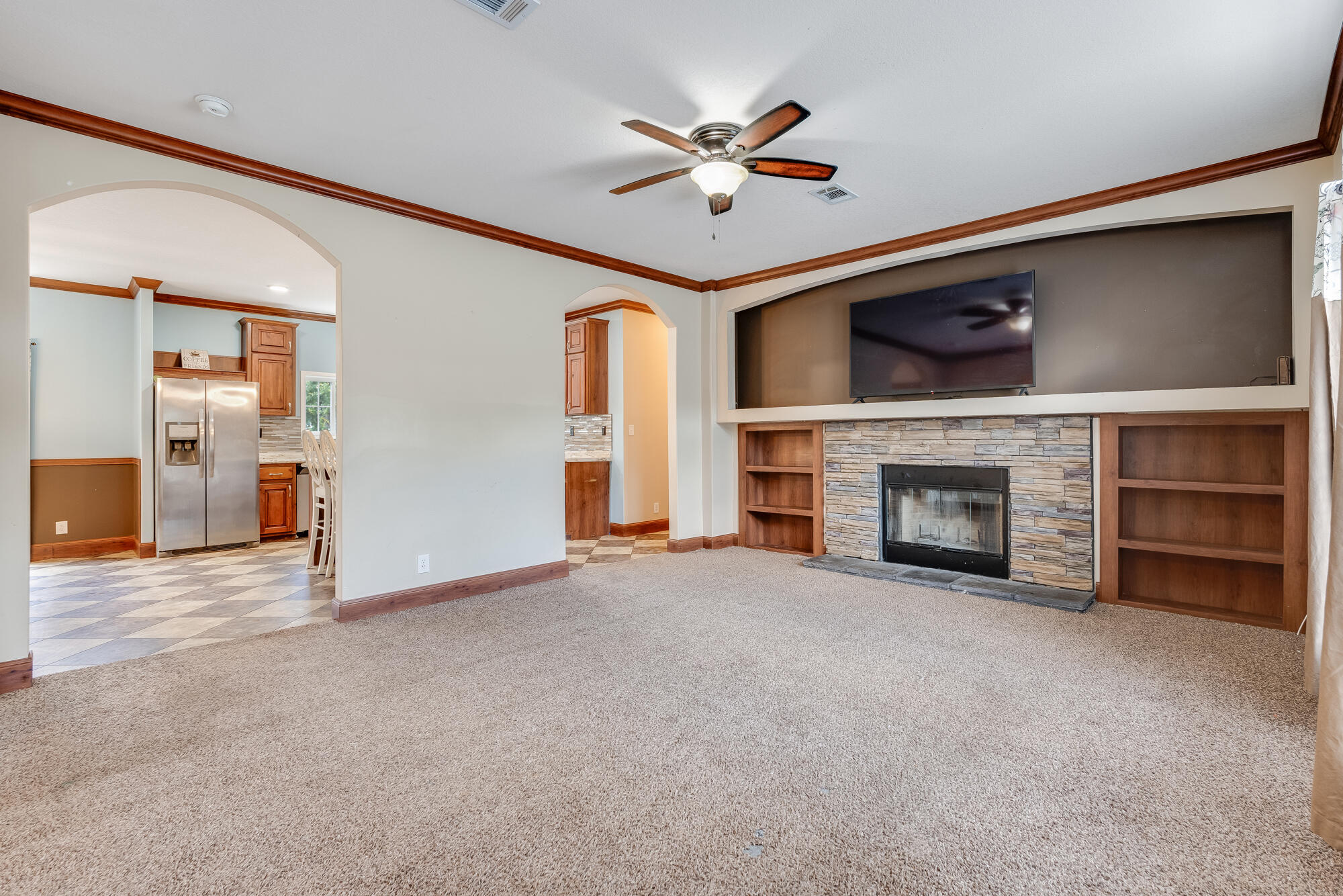 508 Live Oak Street Freeport, FL 32439 - Photo 43 of 47 a view of an empty room with a fireplace and a ceiling fan