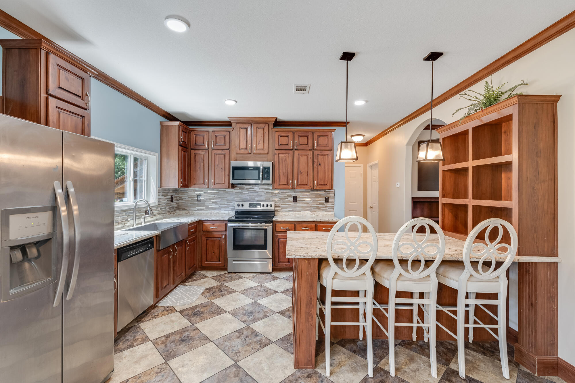 508 Live Oak Street Freeport, FL 32439 - Photo 5 of 47 a kitchen with granite countertop a sink stainless steel appliances and cabinets