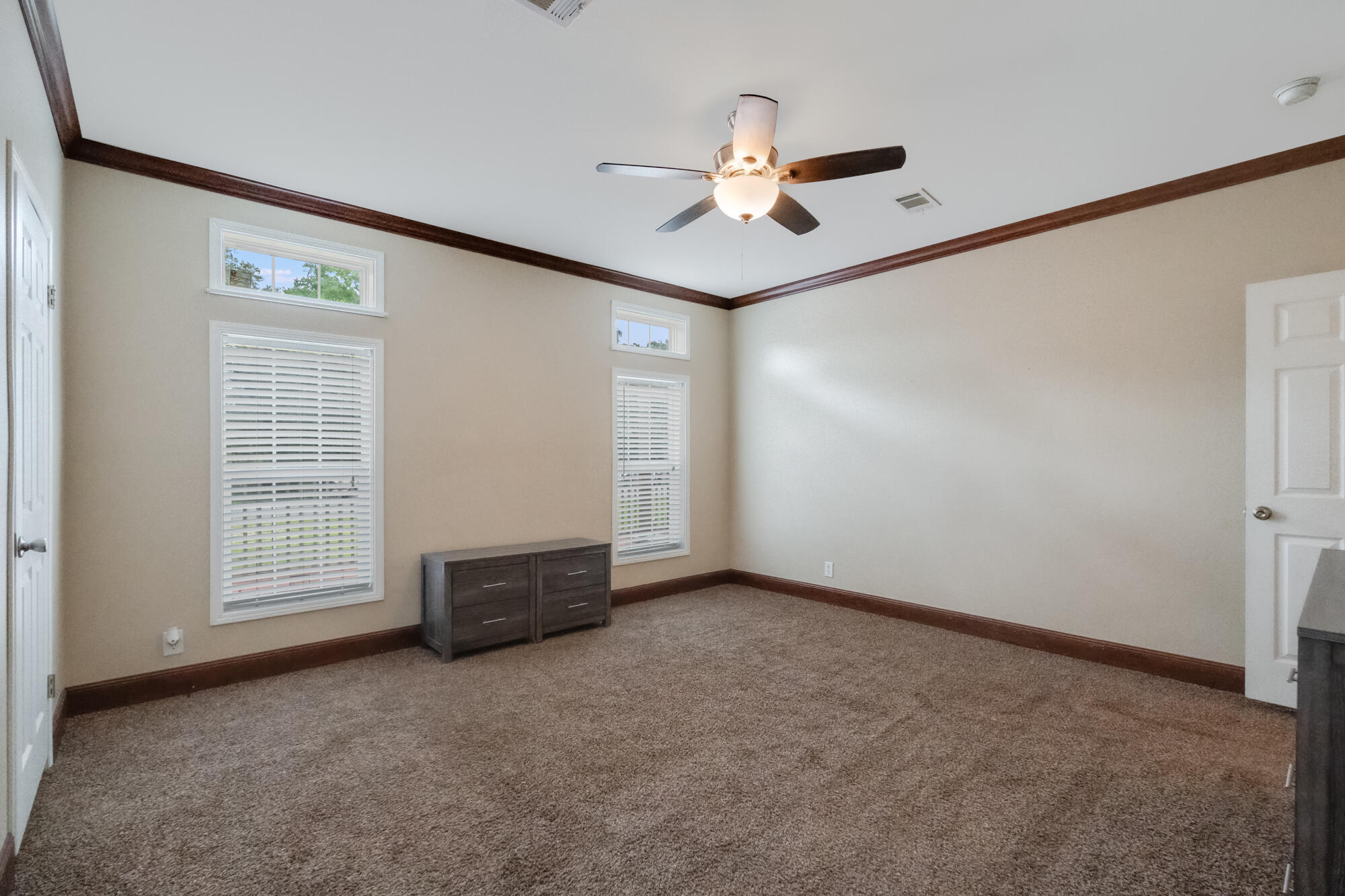 508 Live Oak Street Freeport, FL 32439 - Photo 10 of 47 an empty room with windows and fan