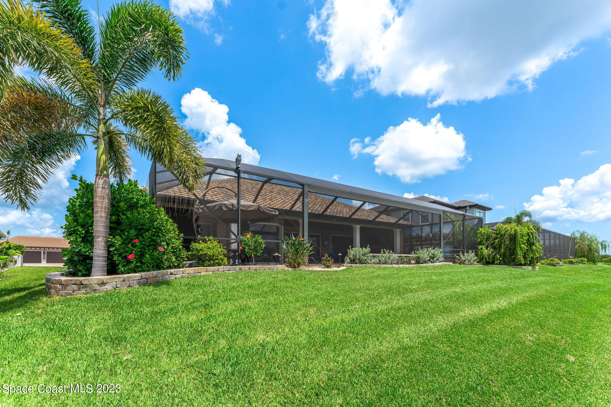 8429 Serrano Circle Melbourne, FL 32940 - Photo 22 of 28 a view of a house with a big yard and a large tree