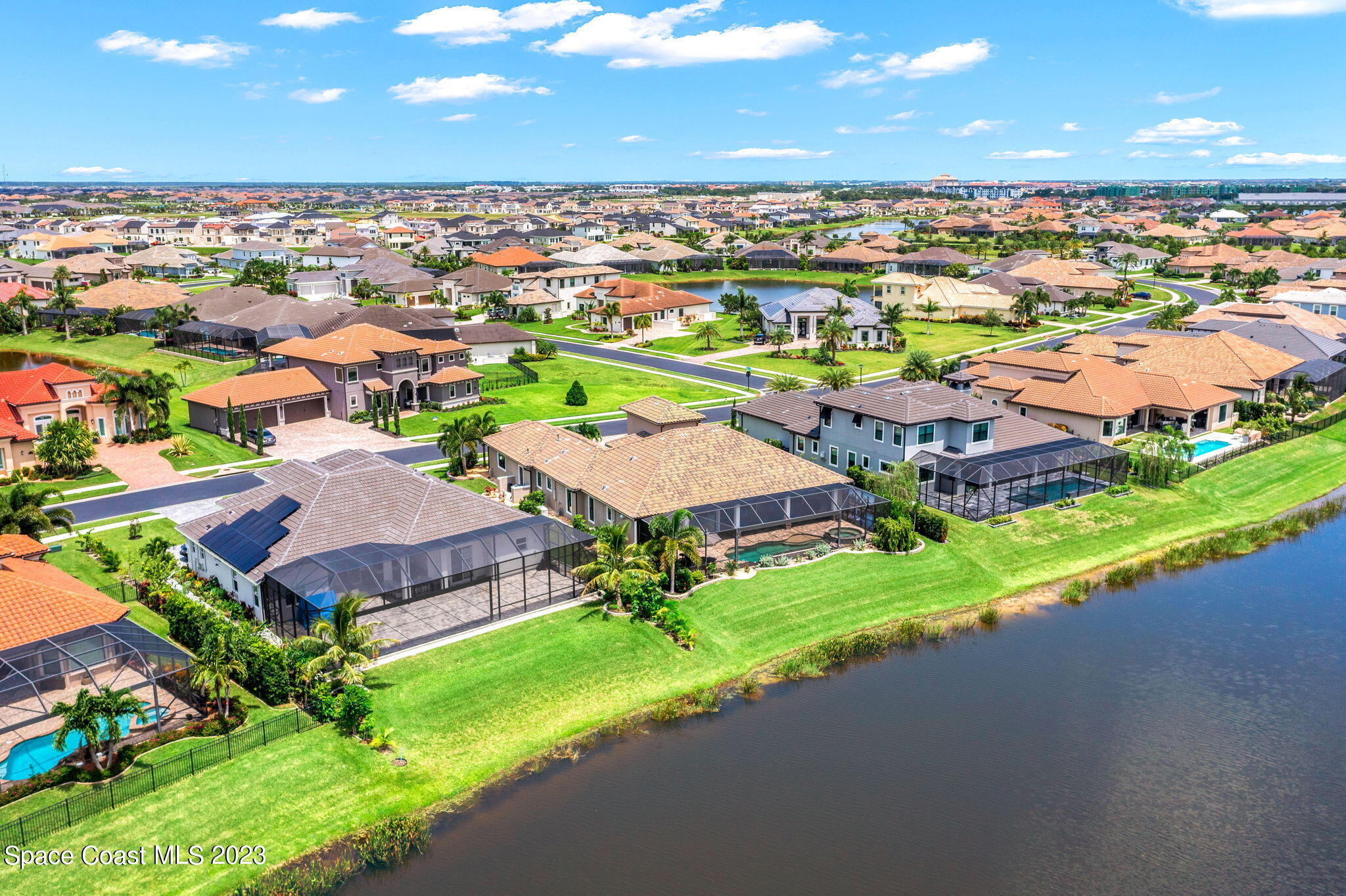 8429 Serrano Circle Melbourne, FL 32940 - Photo 24 of 28 an aerial view of a house with a garden and lake view