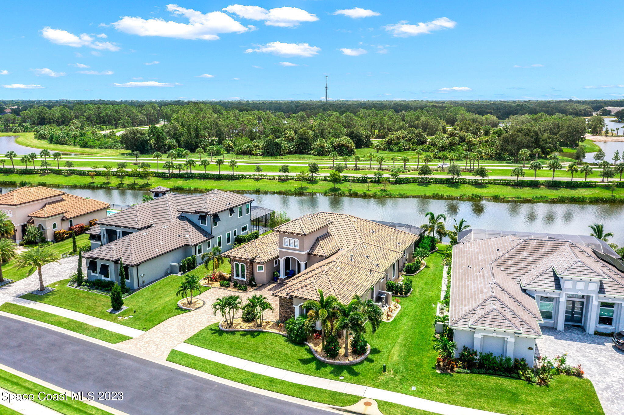 8429 Serrano Circle Melbourne, FL 32940 - Photo 25 of 28 an aerial view of a house with a garden and lake view