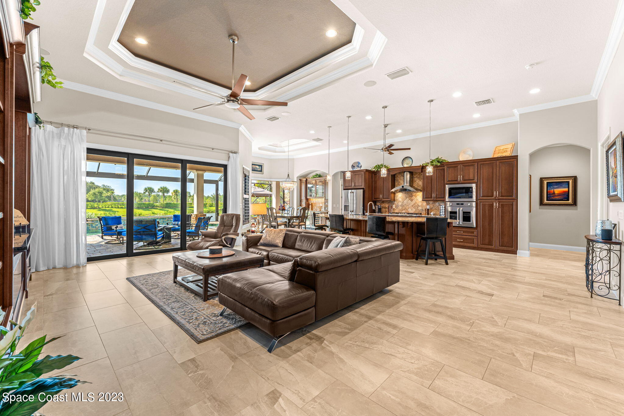 8429 Serrano Circle Melbourne, FL 32940 - Photo 3 of 28 a living room with furniture ceiling fan and a rug