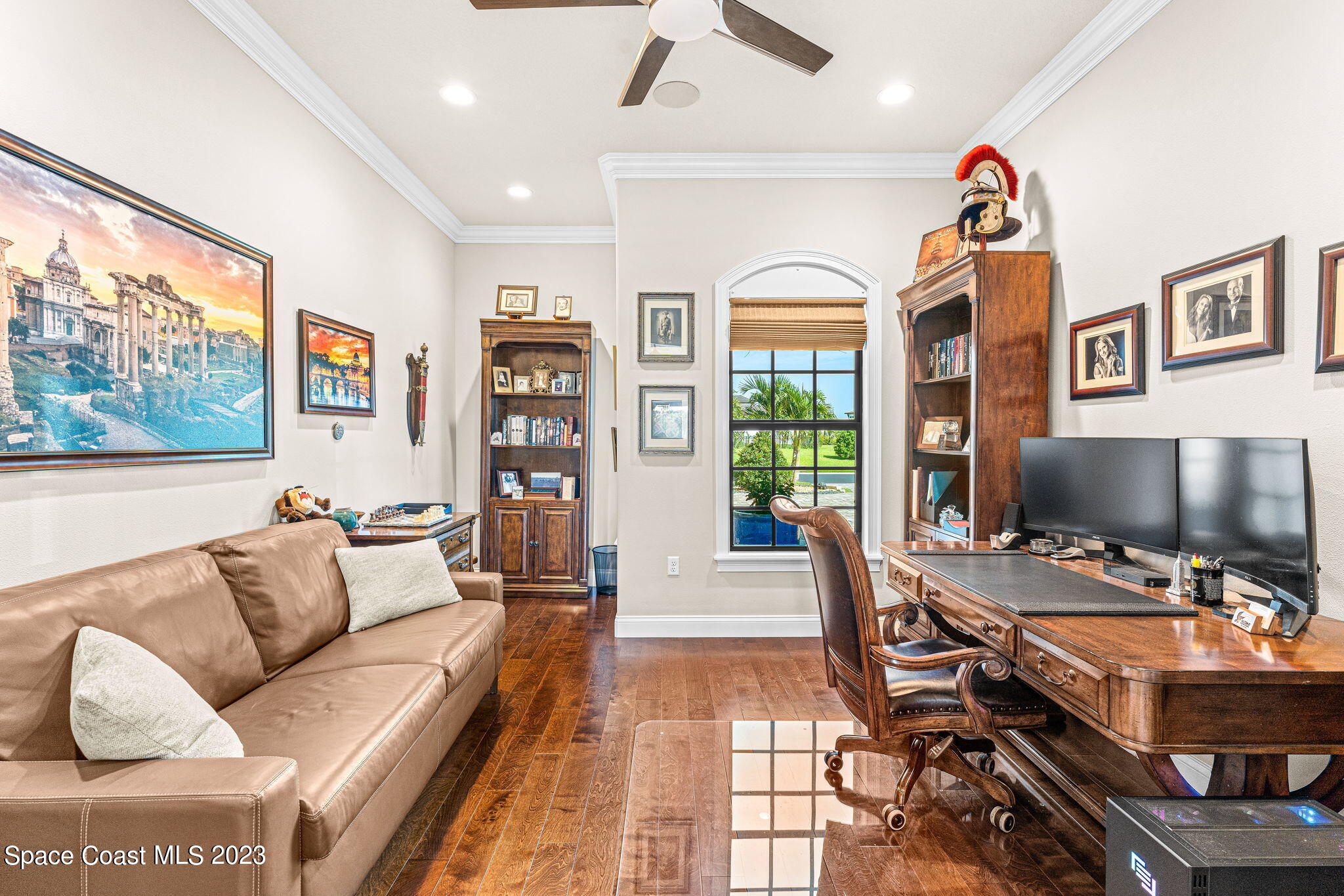 8429 Serrano Circle Melbourne, FL 32940 - Photo 10 of 28 a living room with furniture a flat screen tv and a large window