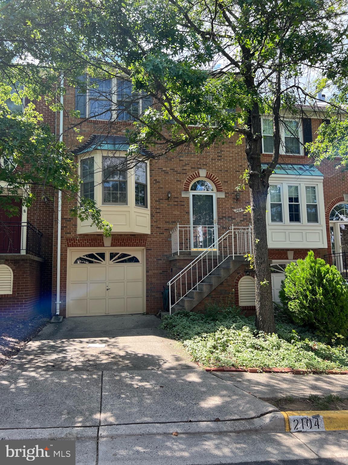 2104 Patty Lane Vienna, VA 22182 - Photo 1 of 19 a front view of a house with a yard and garage