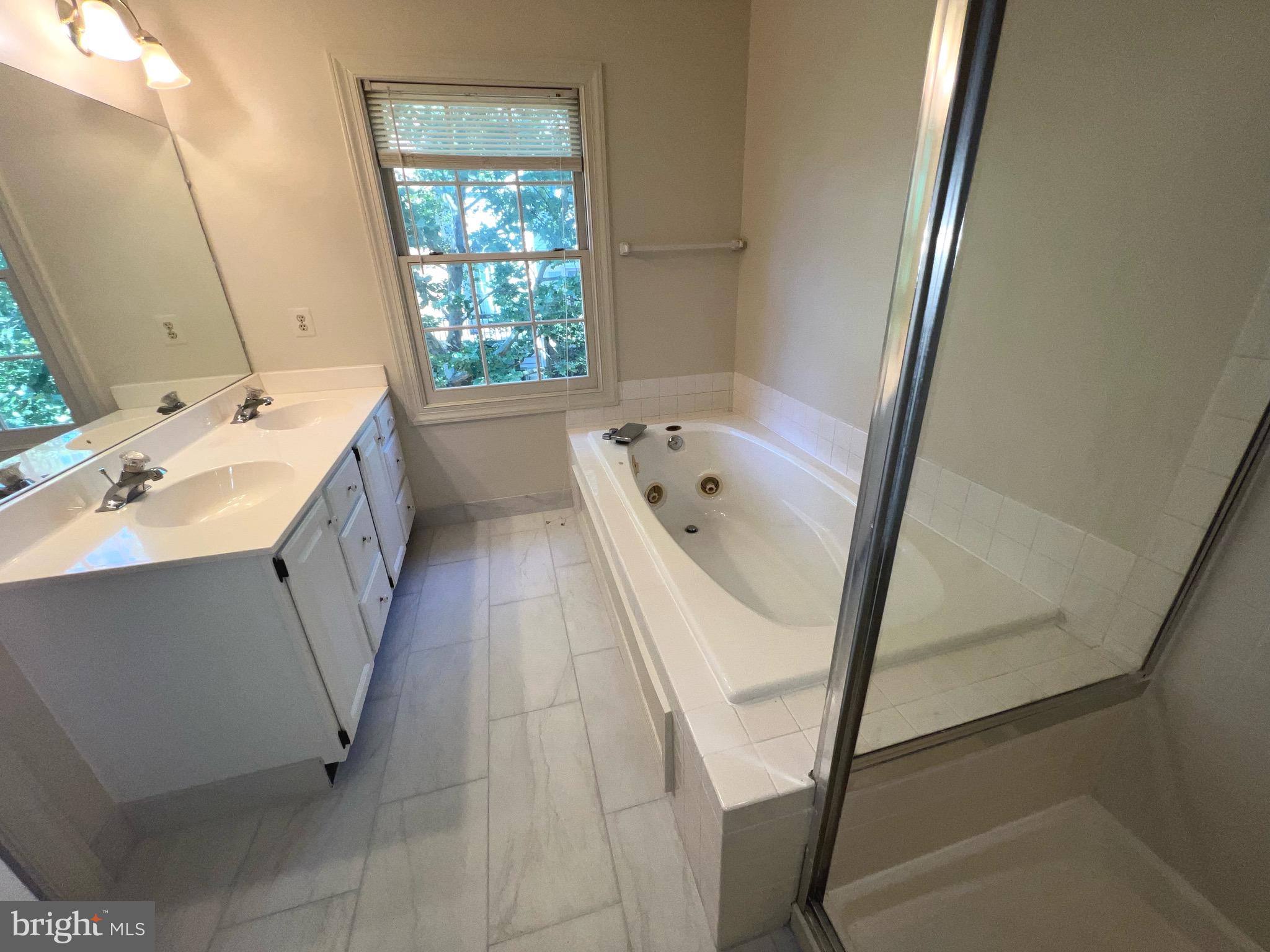 2104 Patty Lane Vienna, VA 22182 - Photo 11 of 19 a bathroom with a sink a bathtub and a window