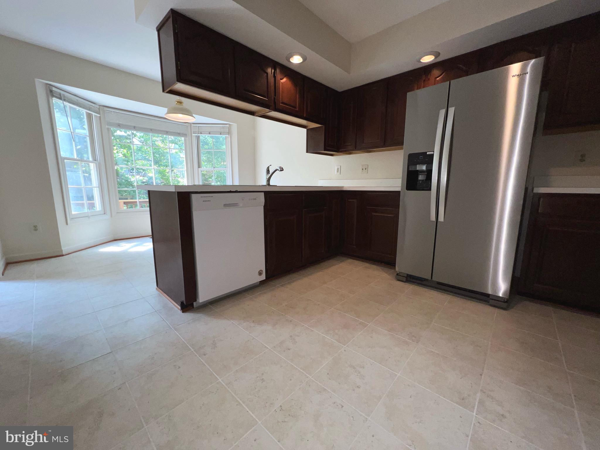 2104 Patty Lane Vienna, VA 22182 - Photo 7 of 19 a kitchen with refrigerator and window