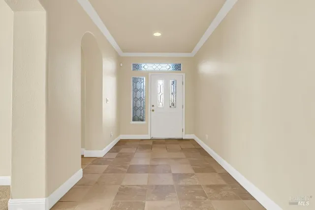 a view of a very nice looking dining room with furniture and chandelier