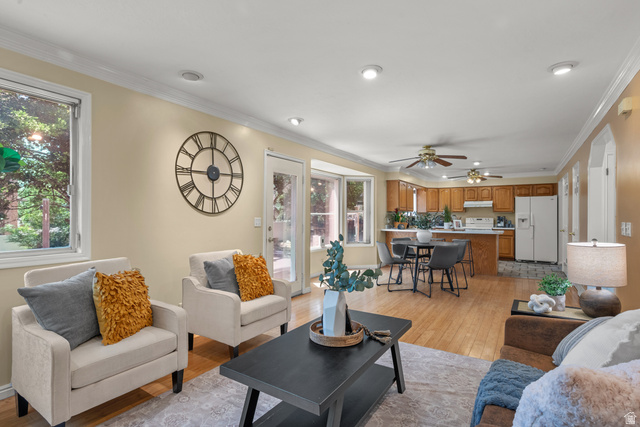 1726 Wasatch Boulevard Sandy, UT 84092 - Photo 5 of 38 Open-concept living space featuring wood-finish flooring, recessed lighting, and crown molding