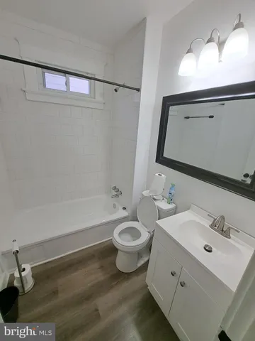a bathroom with a double vanity sink mirror and toilet