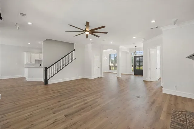 a view of a an empty room with wooden floor