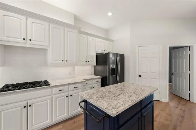 a kitchen with cabinets and stainless steel appliances