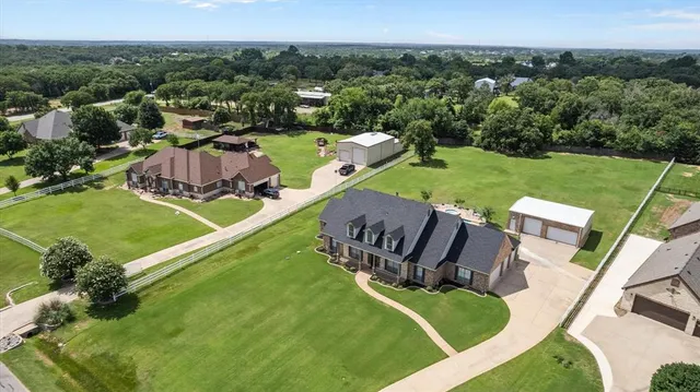 an aerial view of a house with a garden and swimming pool