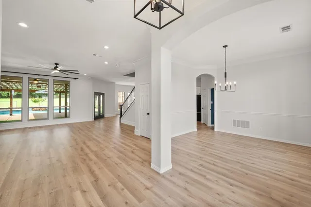 a view of a room with wooden floor window and a kitchen