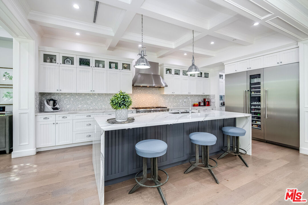 14920 Addison Street Sherman Oaks, CA 91403 - Photo 16 of 52 a kitchen with kitchen island a counter space a sink cabinets and stainless steel appliances