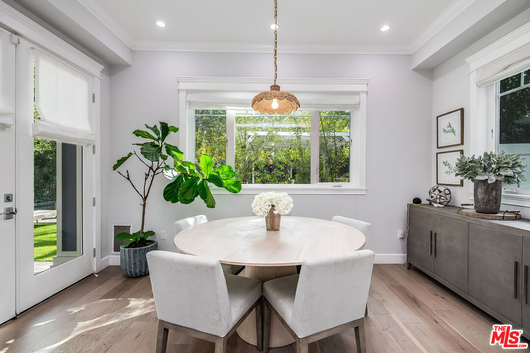 14920 Addison Street Sherman Oaks, CA 91403 - Photo 17 of 52 a dining room with furniture potted plants and wooden floor