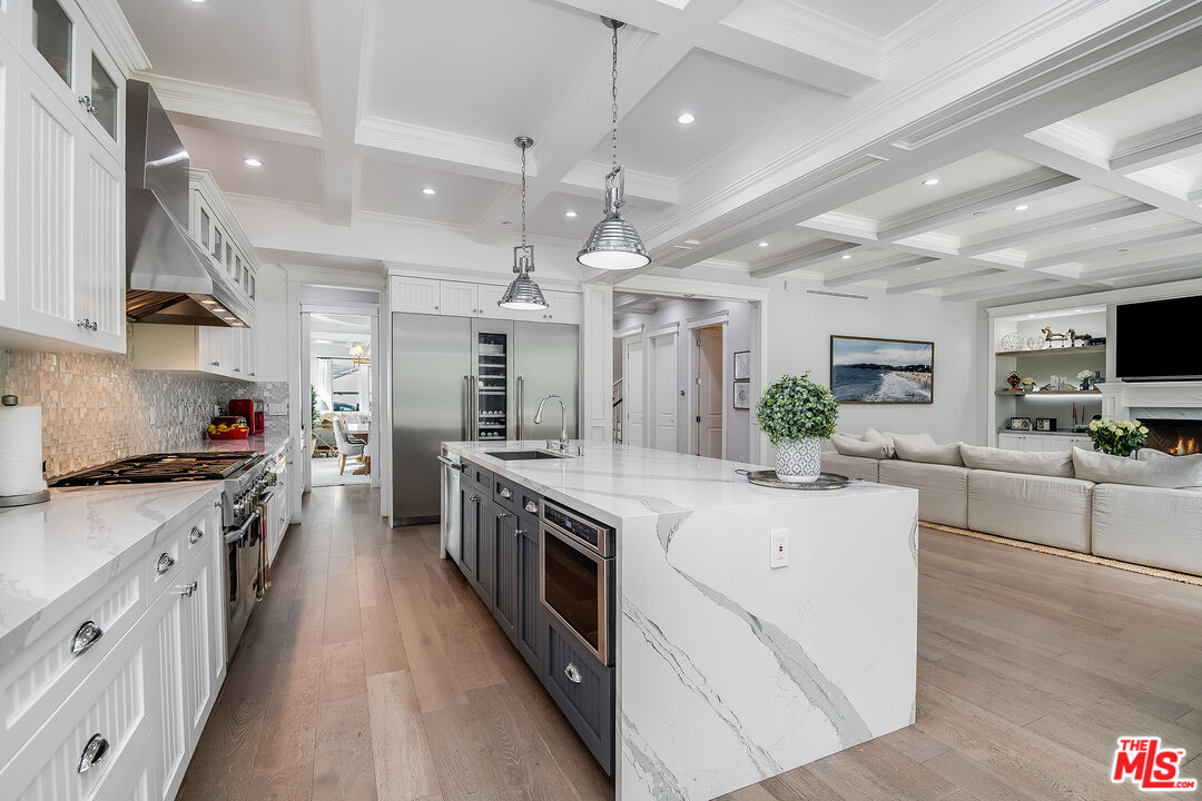 14920 Addison Street Sherman Oaks, CA 91403 - Photo 19 of 52 a large kitchen with stainless steel appliances lots of counter space and wooden floor